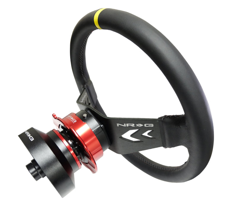 NRG reinforced steering wheel with 350mm black leather, arrow-cut 2-spoke design, yellow center mark, and NRG branding.