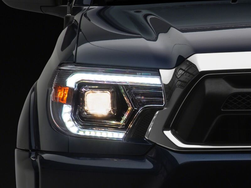 Raxiom 12-15 Toyota Tacoma Axial Series chrome projector headlights with clear lenses and switchback LED turn signals.