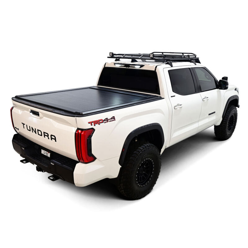 Westin manual retractable roll-up tonneau cover in black for 22-26 Toyota Tundra 5.5ft bed, shown on truck bed.