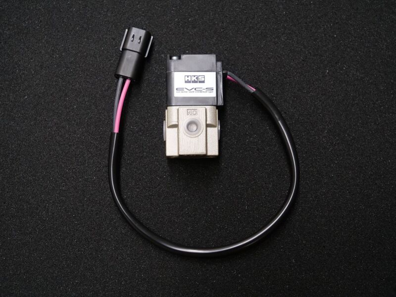 HKS EVC S2 boost controller with BOV and accessories, showing the device with control knobs and connection ports.