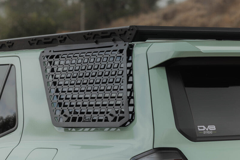 DV8 Offroad Toyota 4Runner exterior window Molle panel for DV8 roof rack, mounted on driver side, part of vehicle exterior trim.