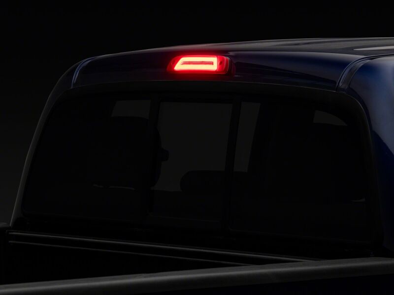 Red Raxiom Axial Series LED third brake light for Toyota Tacoma 2005-2015, mounted on the vehicle’s rear window.