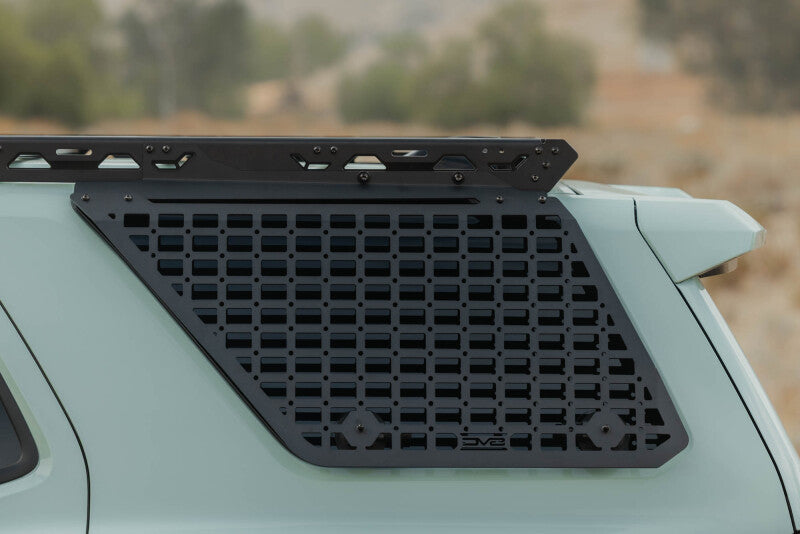 DV8 Offroad Toyota 4Runner exterior window molle panel for DV8 roof rack, driver side, mounted on vehicle exterior trim.