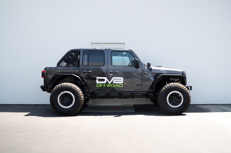 DV8 Offroad 18-23 Jeep Wrangler JL 4-door FS-15 Series rock sliders mounted on vehicle side for protection and style
