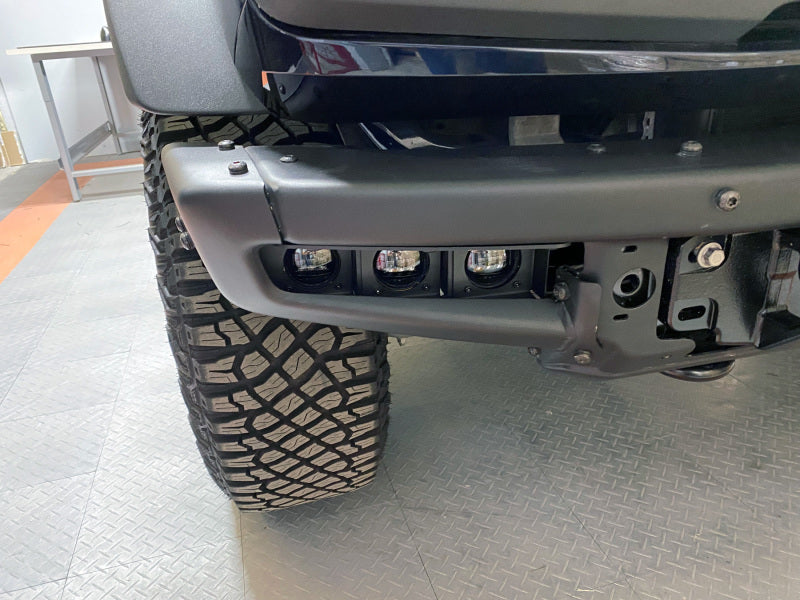 ORACLE Lighting Ford Bronco 21-22 triple LED fog light kit with white lights installed on steel bumper.