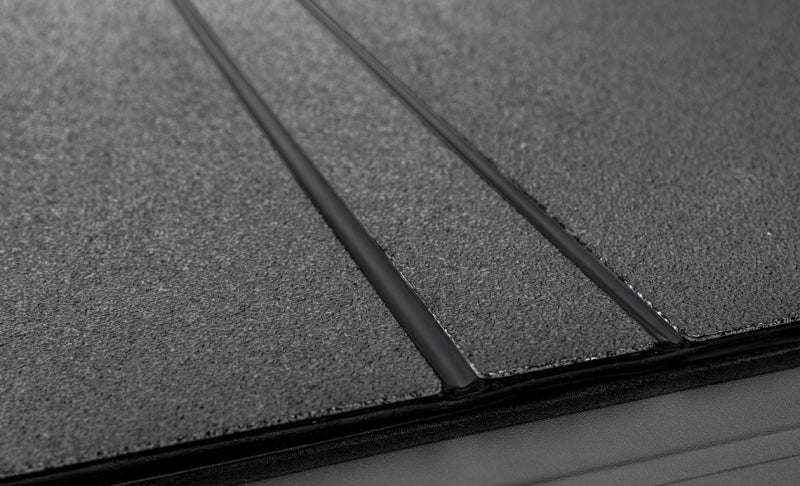 Access LOMAX tri-fold black urethane truck bed cover on a 19+ Chevrolet Silverado 1500 with 6ft 6in bed, exterior truck bed accessory