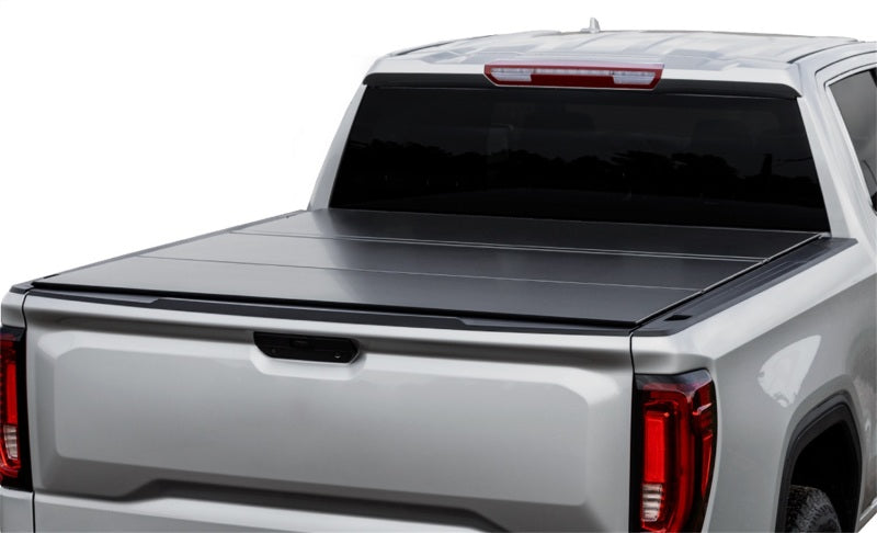 Access LOMAX tri-fold truck bed cover on a 2020+ Chevy/GMC 2500/3500 with matte black finish on full-size 6ft 8in bed.