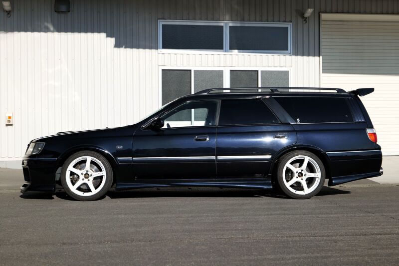 HKS HIPERMAX S WGNC34 coilover kit for 4WD Toyota models, showing silver and black coilover components on a vehicle.