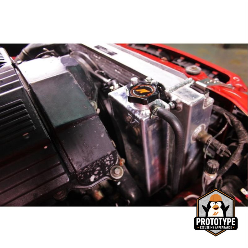 Mishimoto aluminum coolant expansion tank for 92-99 BMW 3 Series, featuring a sleek silver design and mounting points.