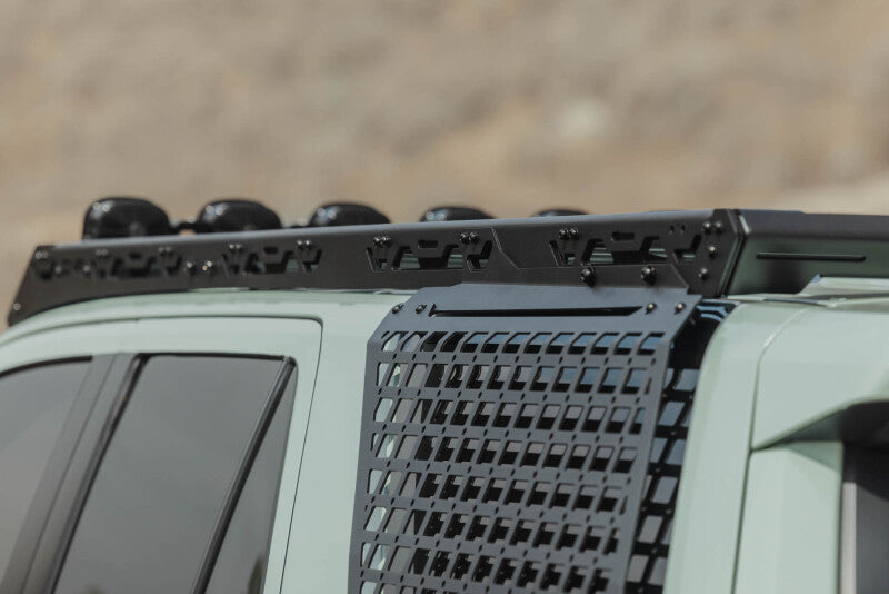 DV8 Offroad Toyota 4Runner exterior window Molle panel for DV8 roof rack on driver side, part of the vehicle's exterior trim.