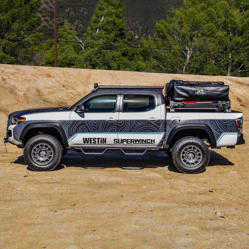 Westin 16-23 Toyota Tacoma Mesa roof rack installed on vehicle, showing sturdy metal construction and mounting points for cargo.