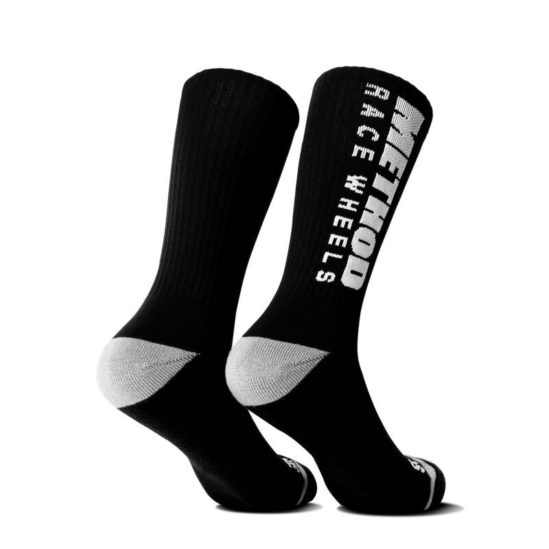 Black Method Wheels logo performance socks with the Method brand logo visible on the fabric, designed for comfort and style.