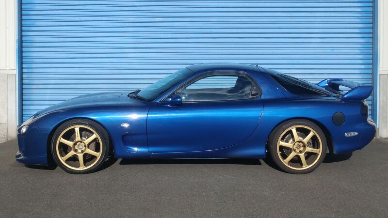 HKS HIPERMAX S FD3S coilovers installed on a Mazda RX-7, showcasing adjustable suspension components and sleek design.