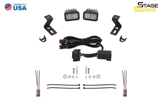 Diode Dynamics Stage Series reverse light mounting kit for 2019-present Ram trucks, showing the black metal light mounts.
