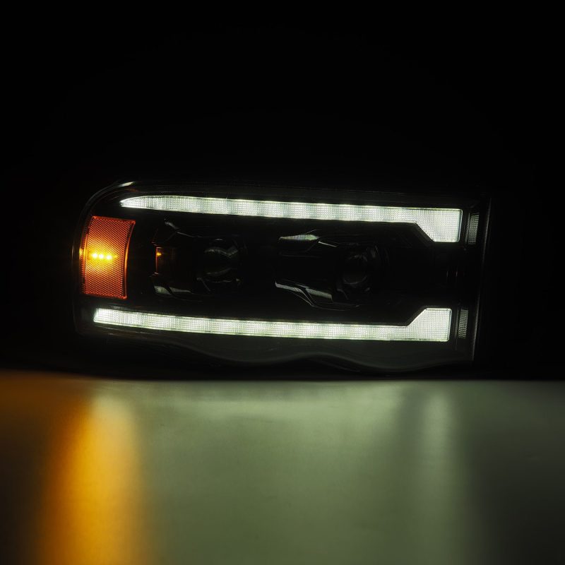 AlphaRex Alpha Black projector headlights with sequential signal for Dodge Ram 1500 2002-2005, plank style, high-performance lighting.