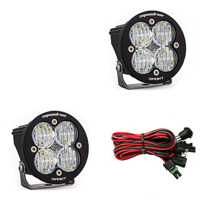 Pair of Baja Designs Squadron R Sport LED light pods with clear lenses, designed for wide cornering illumination on off-road vehicles.