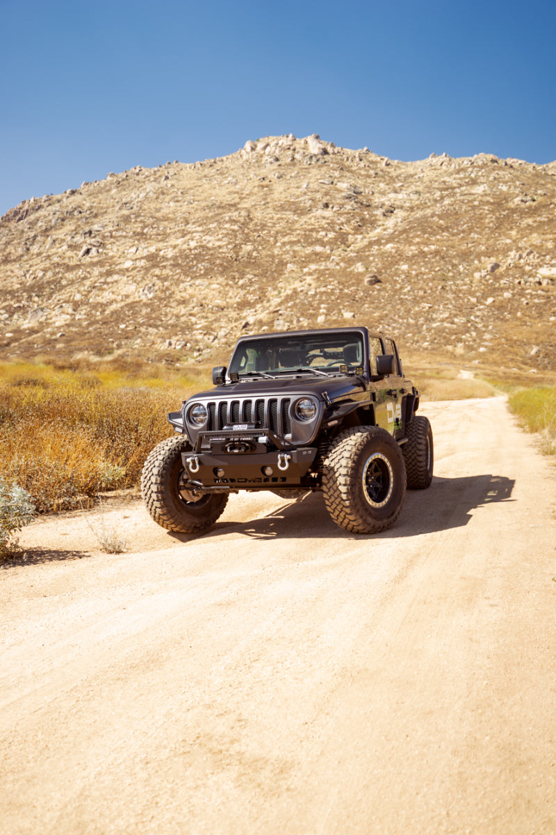 Steel DV8 Offroad FS-25 stubby front bumper with plated bull bar on Jeep Wrangler and Gladiator JT/JK/JL, rugged offroad style
