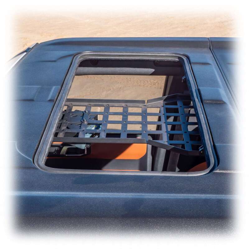 Turn Offroad 2021+ Ford Bronco cage brace with Molle pattern and center mount, mounted on the vehicle’s offroad cage for utility.