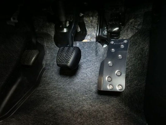 Cusco wide accelerator pedal cover kit for 2023+ Toyota GR Corolla and 2020+ GR Yaris, made of durable material, installed on vehicle.