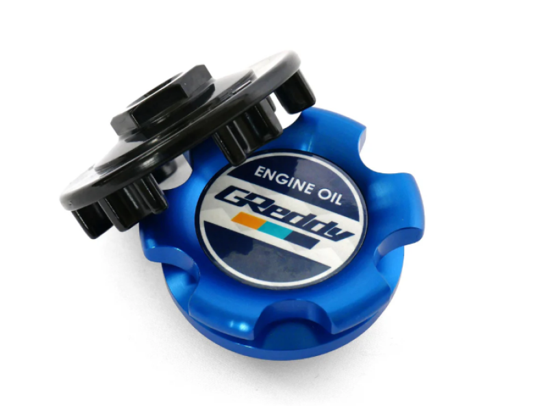 Blue GReddy Type-B oil filler cap for Toyota M37-P3.0 engine, made of durable metal with a sleek design.