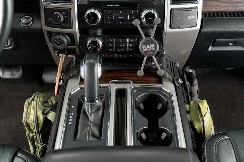 DV8 Offroad Ford F150/F250/F350 center console Molle panels and device mount installed on vehicle interior trim.