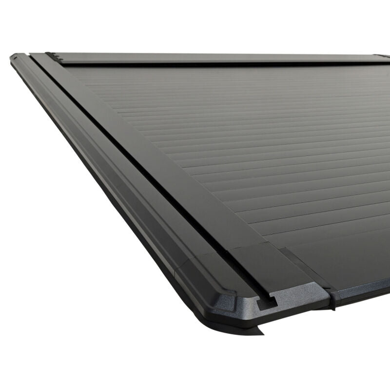 Westin 24-26 Toyota Tacoma black roll-up retractable tonneau cover installed on 5ft truck bed, providing secure cargo protection.