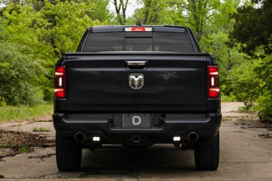 Diode Dynamics Stage Series reverse light mounting kit installed on a 2019-present Ram truck, showing the durable metal brackets.