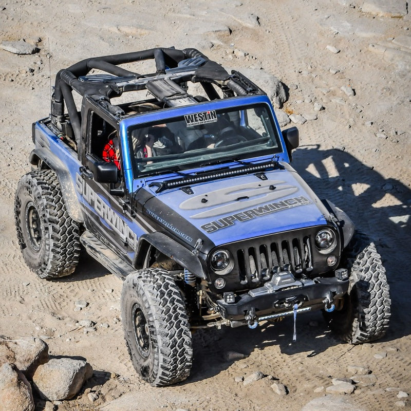 Superwinch 10,000 lbs 12V DC winch with synthetic rope, showing the winch drum and synthetic cable in detail.