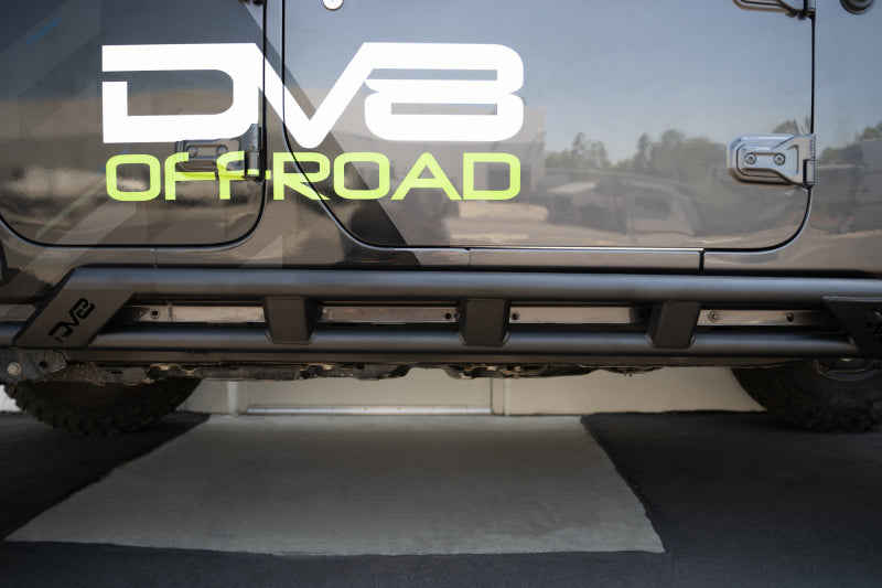 DV8 Offroad Jeep Wrangler JL 4-door FS-15 Series Rock Sliders mounted on body exterior, providing protection and rugged off-road style.