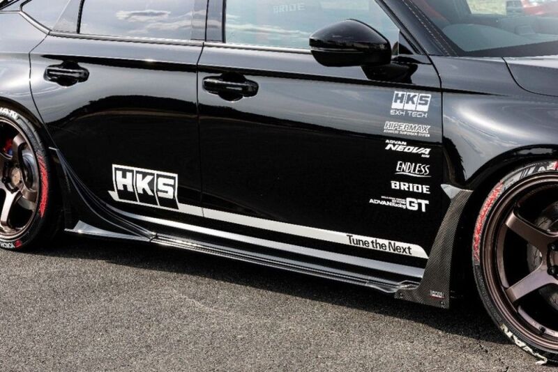 HKS Type-S FL5 body kit S-skirt installed on a vehicle, showcasing sleek, aerodynamic design and smooth finish.