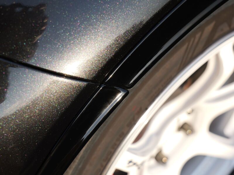 HKS GR Corolla GZEA14H fender molding from body kit, close-up view showing black finish and textured surface.