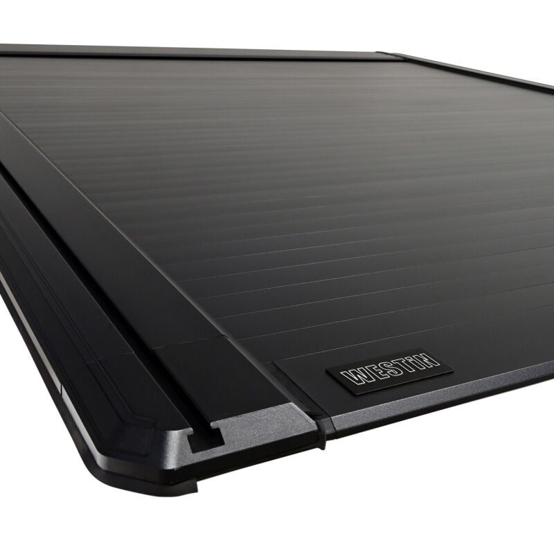 Westin electric retractable tonneau cover on a 2019-2026 Ram 1500 with a 6.4ft bed in black, covering the truck bed.