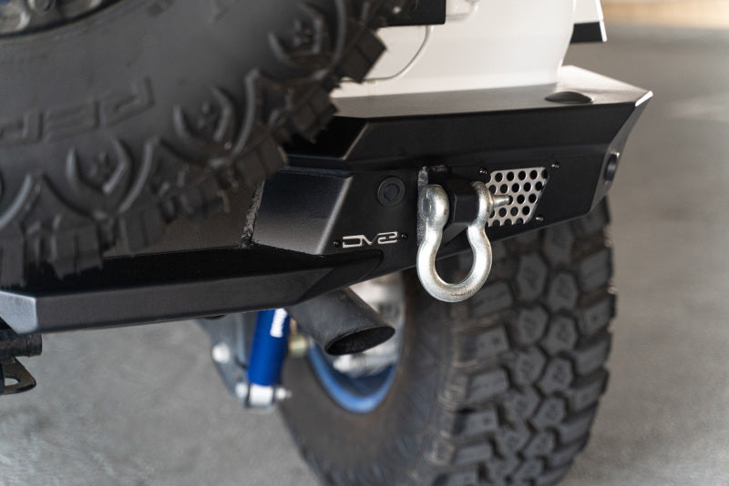 DV8 Offroad steel rear bumper with optional tire carrier installed on a 2018 Jeep Wrangler JL, rugged off-road bumper design