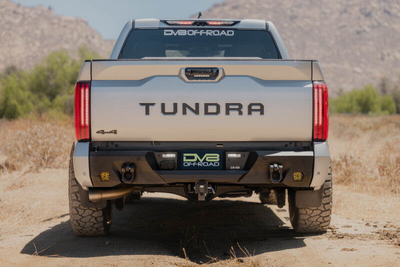 Steel rear bumper for Toyota Tundra by DV8 Offroad, part of the Spec Series, with a rugged, durable design and mounting brackets.
