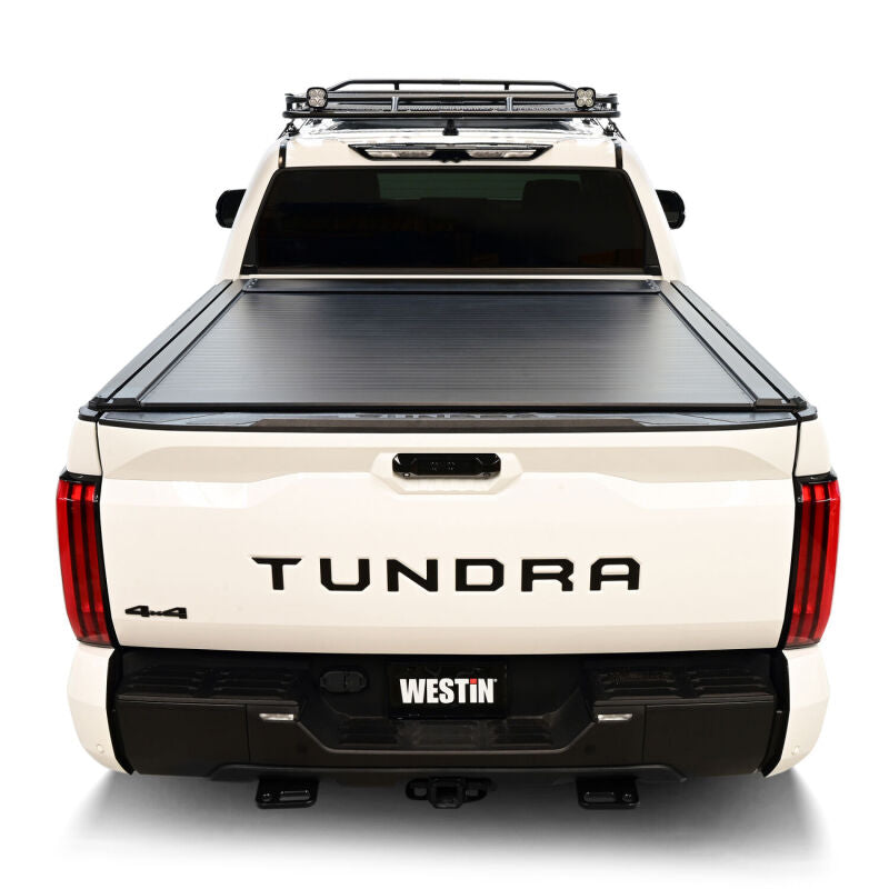 Westin manual retractable roll-up tonneau cover for 2022-2026 Toyota Tundra 5.5ft bed in black, shown rolled up on truck bed