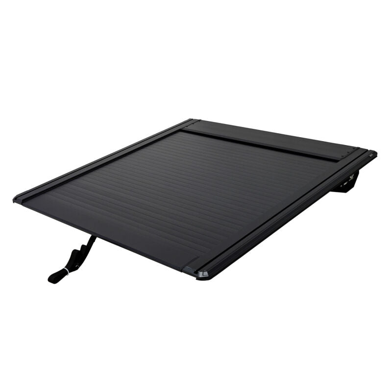 Westin black 5ft bed roll-up tonneau cover on Toyota Tacoma truck, showing the retractable design and sleek finish.