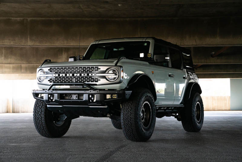 DV8 Offroad light mounts for 2021-2022 Ford Bronco factory bumper bull bar, black finish, designed for off-road vehicle lighting.
