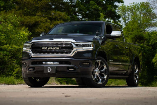 Diode Dynamics SS18 Stealth Bracket Kit light mounts installed on a 2019-present Ram truck, showing sleek black brackets and mounting points.