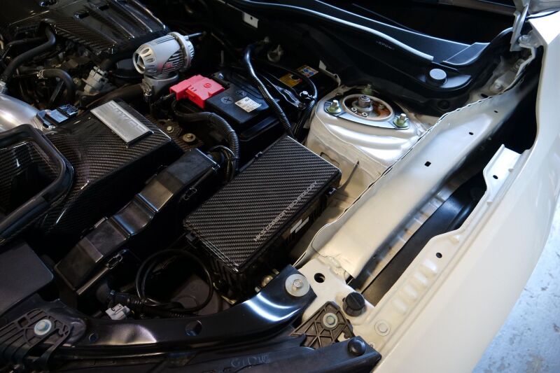 HKS dry carbon fiber fuse box cover for FK8 Honda Civic, showcasing sleek black carbon accessories with textured finish.