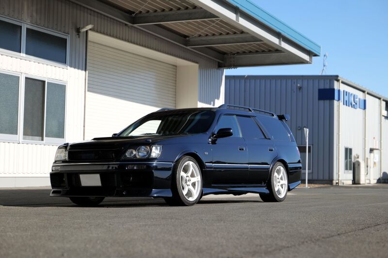 HKS HIPERMAX S WGNC34 coilover suspension kit for 4WD AT models, including shock absorbers and springs, on a car.