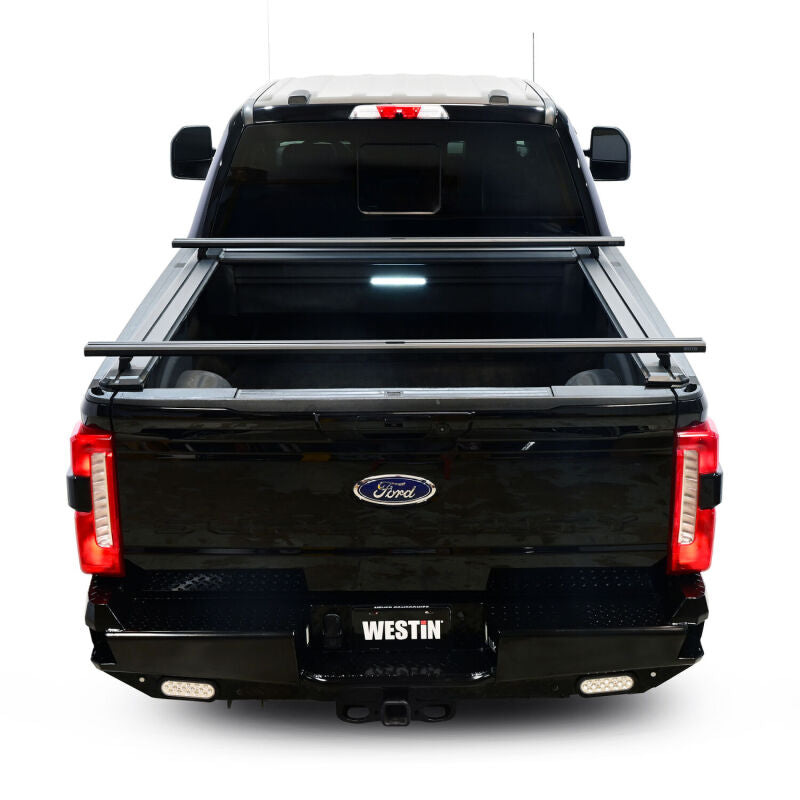 Westin retractable tonneau cover in black on a Ford F-250/F-350 SD with a 6.8ft bed, showcasing its sleek design and secure fit.