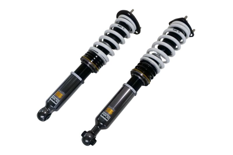 HKS HIPERMAX S SXE10 coilover suspension kit installed on a vehicle, showcasing adjustable shock absorbers and coil spring components.