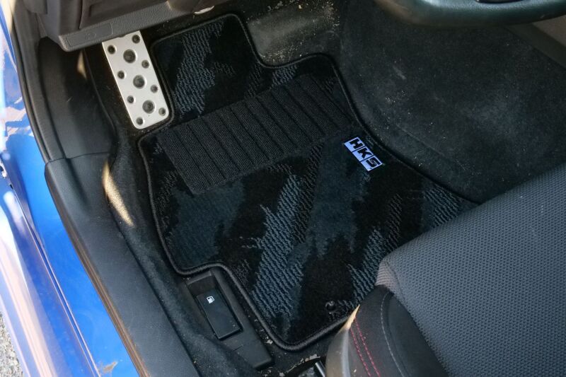 HKS carpeted floor mats full set for VA vehicle, driver and passenger side, left-hand drive model, shown in black.