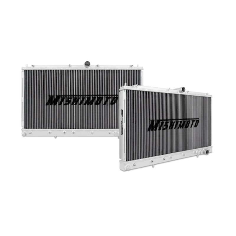 Mishimoto aluminum radiator for 91-99 Mitsubishi 3000GT Turbo manual transmission, with cooling fins and inlet/outlet hoses visible.
