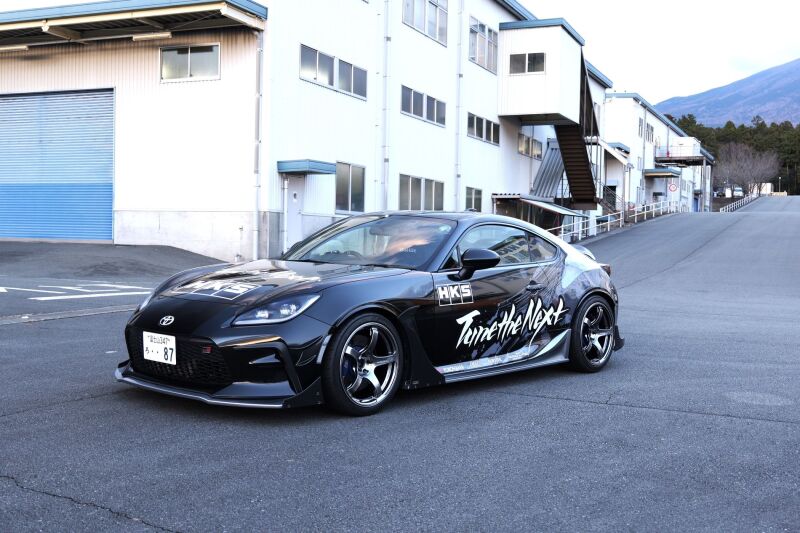 HKS 2022+ Toyota GR86 and Subaru BRZ fender molding kit installed on the car's front fender, showcasing sleek body kit design
