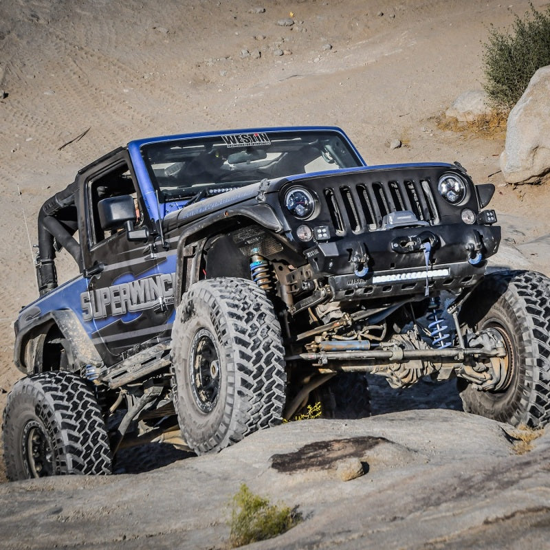 Superwinch 10,000 lb 12V DC winch with synthetic 3/8 inch x 80 ft rope, showcasing the winch and synthetic cable in a rugged setting.