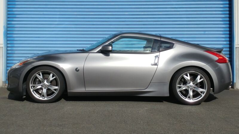 HKS HIPERMAX S Z34 coilover suspension kit installed on a Nissan 370Z, showing adjustable shocks and spring components.