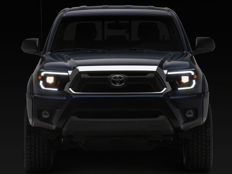 Raxiom black housing Toyota Tacoma axial series projector headlights with clear lens for 2012-2015 models.