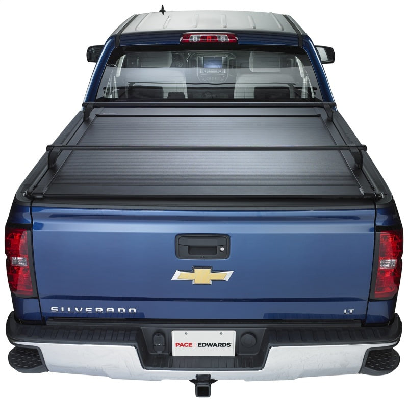 Pace Edwards Ultragroove retractable tonneau cover on Nissan Titan King Cab truck bed, showing its sleek, durable design in black.