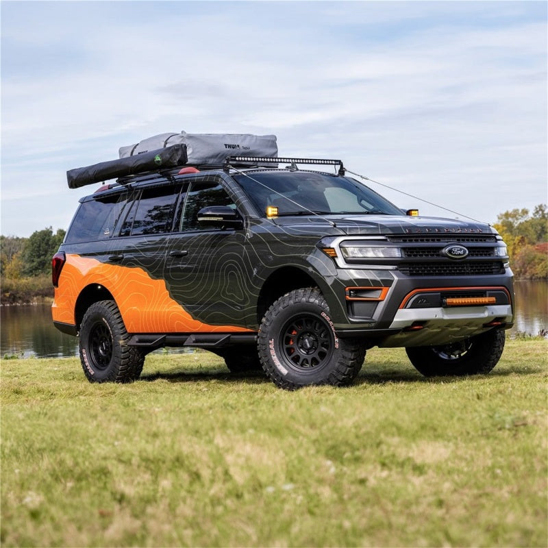 Rigid Industries 18-24 Ford Expedition 360 LED light bars and cubes installed on vehicle front grille for enhanced visibility.